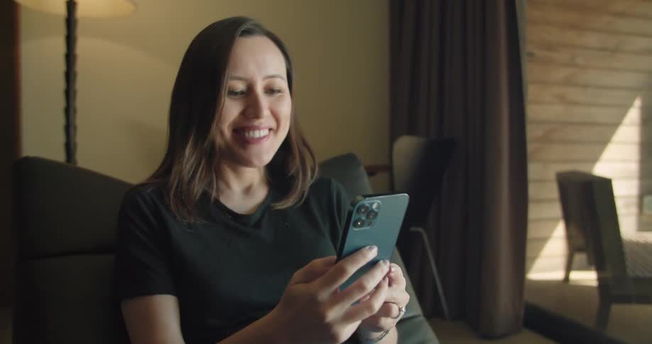 A woman sitting and using a phone
