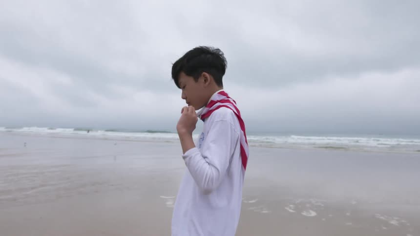 A child is walking across the beach during the day
