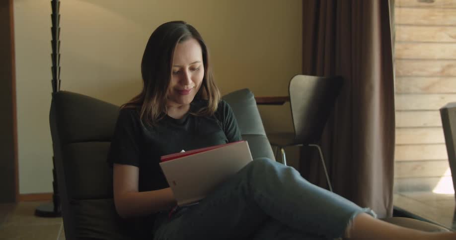 A woman writing in a notebook