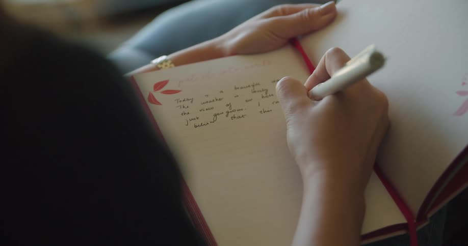 A woman writing in a notebook