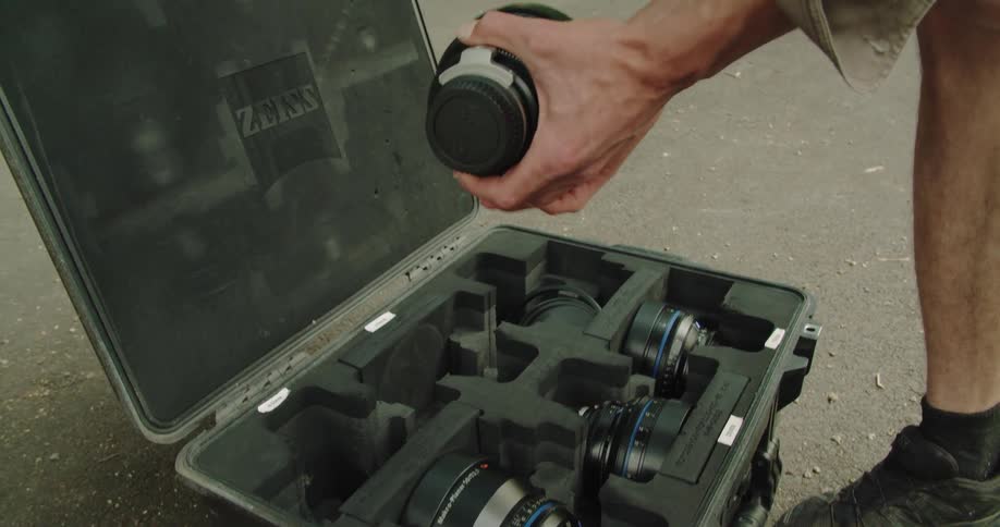 A man works with camera equipment outdoors