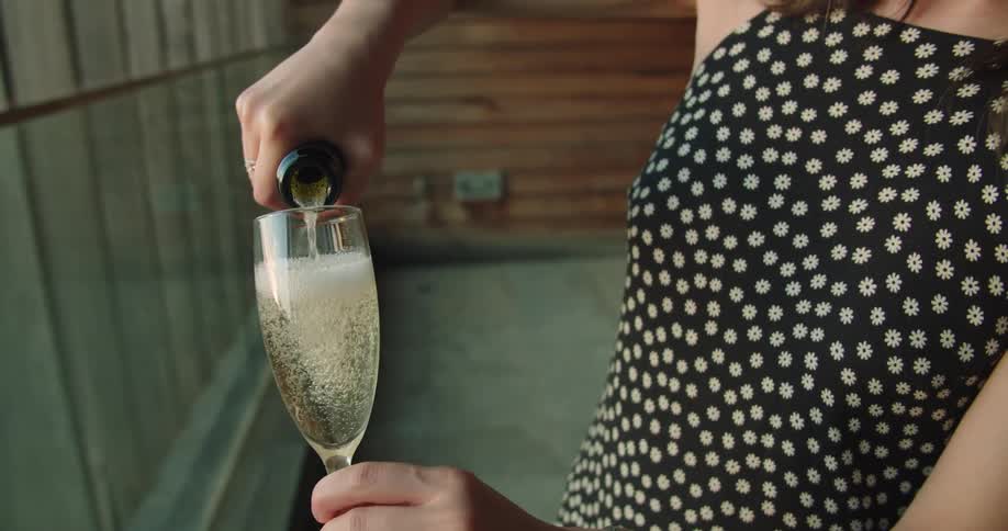 A woman pouring liquid into a glass