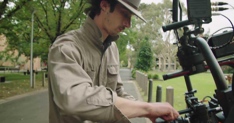A man setting up a camera
