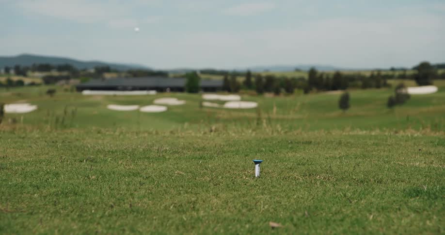 A golf club hitting a golf ball