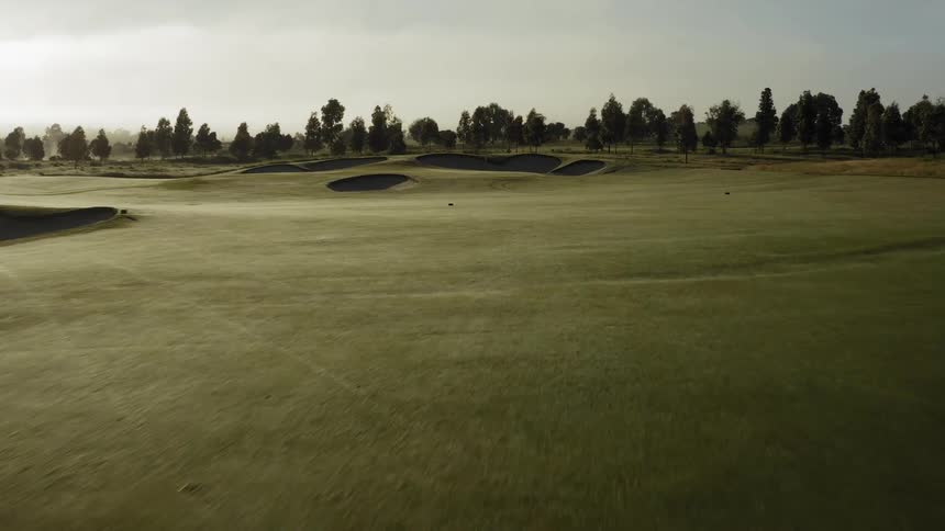 Golf course with many trees in the distance
