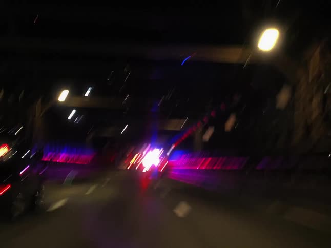 Vehicle drives over a bridge at night