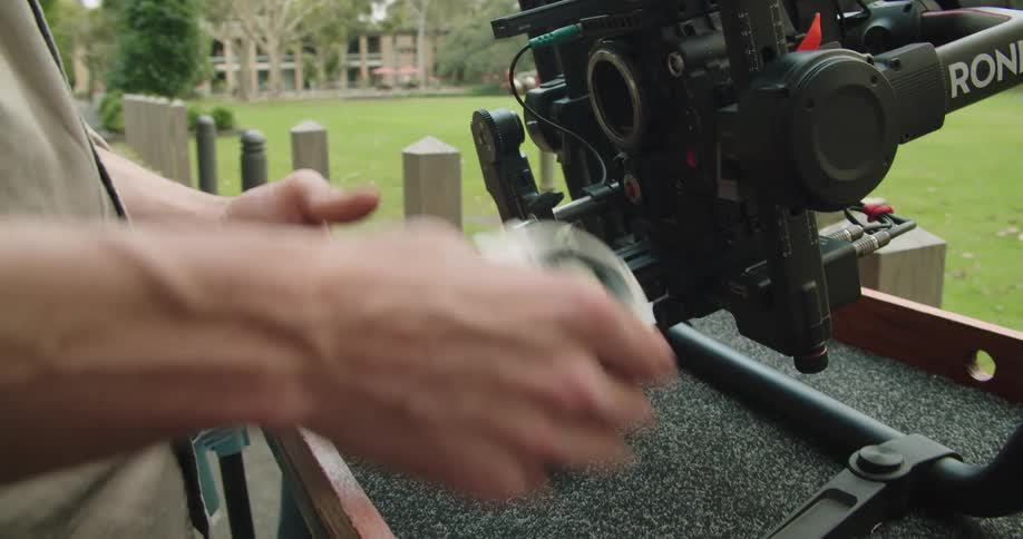 A man is changing the lens on his camera