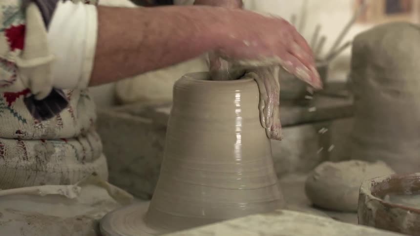A person making a piece of pottery