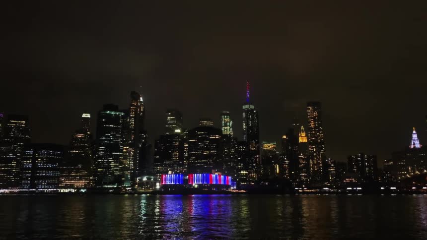 A river with a city skyline with buildings and skyscrapers and the sky and clouds in the background