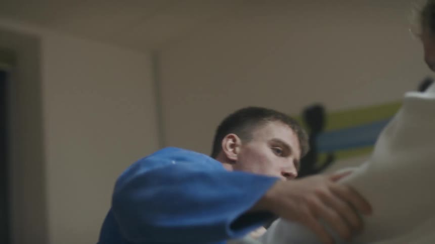Two men fight and try to throw each other to the ground