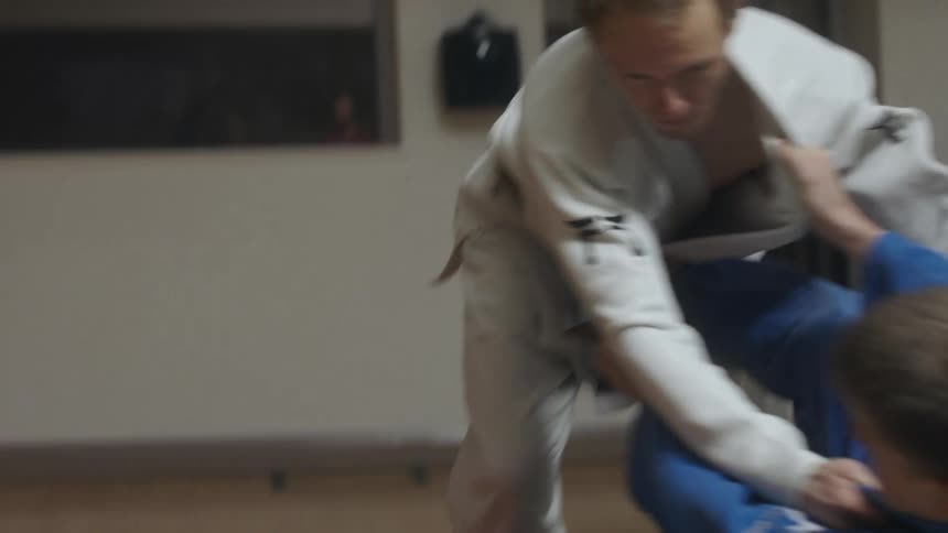 Slow motion footage of two people wrestling