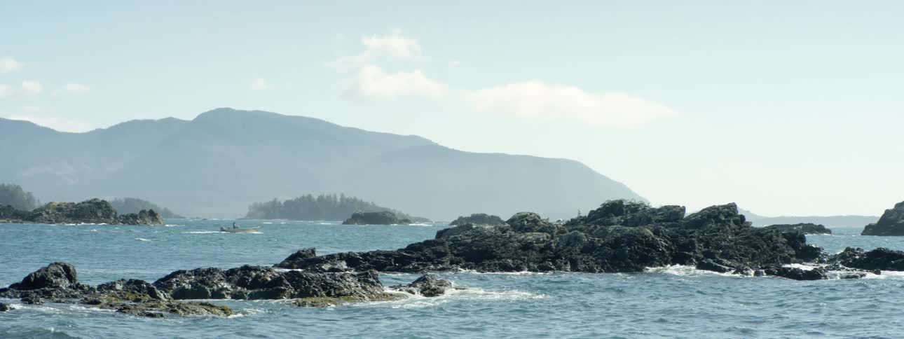 A boat rides in the rough waters