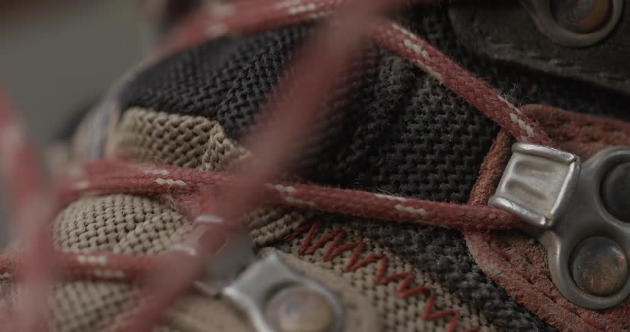 Someone tightening the laces on their boots