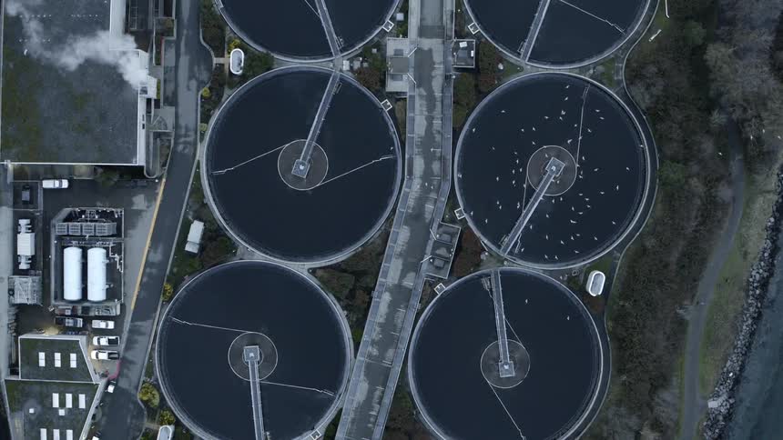Birds eye view of large circular treatment tanks for urban wastewater