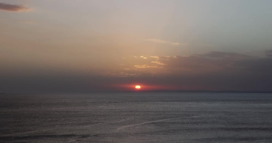 The sun setting over the ocean