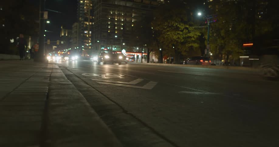 Vehicular traffic on the street of the citys downtown at night