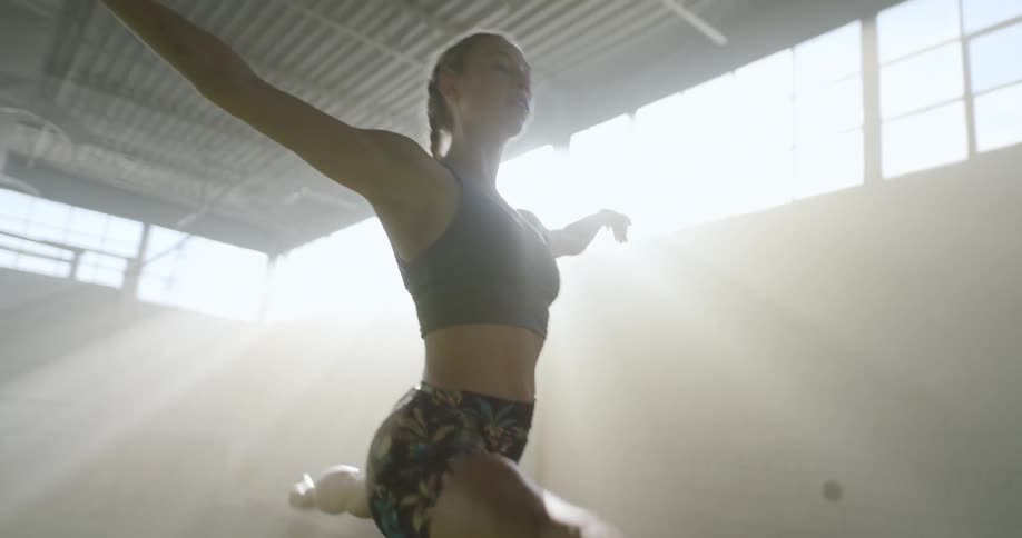 A woman in a room running jumping and skipping