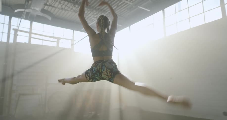 A woman in a room running jumping and skipping