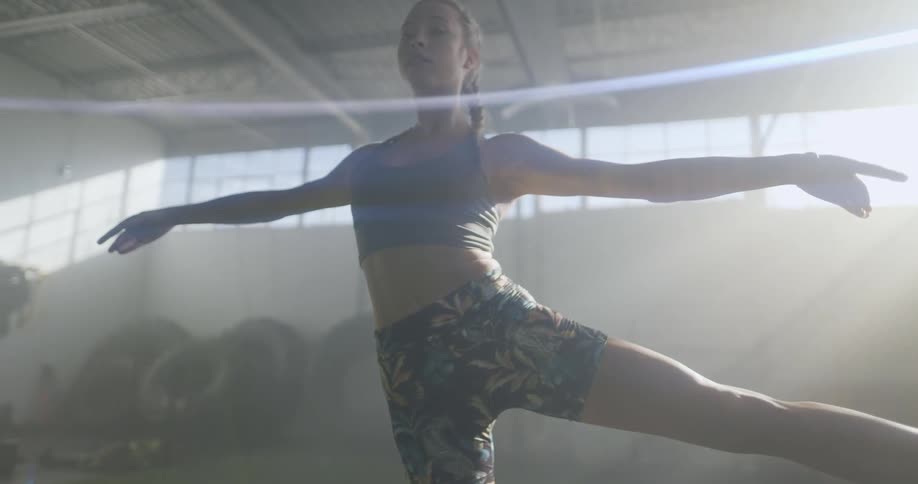 A woman doing stretches in a gym