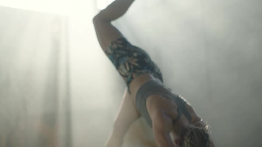 A young woman does yoga indoors