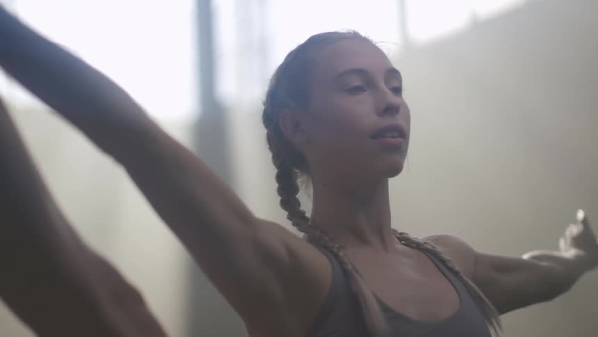 A teenage girl stretches as she exercises