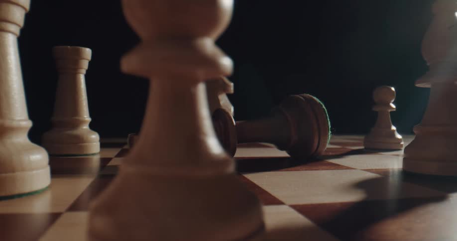 A chessboard with a piece being knocked over