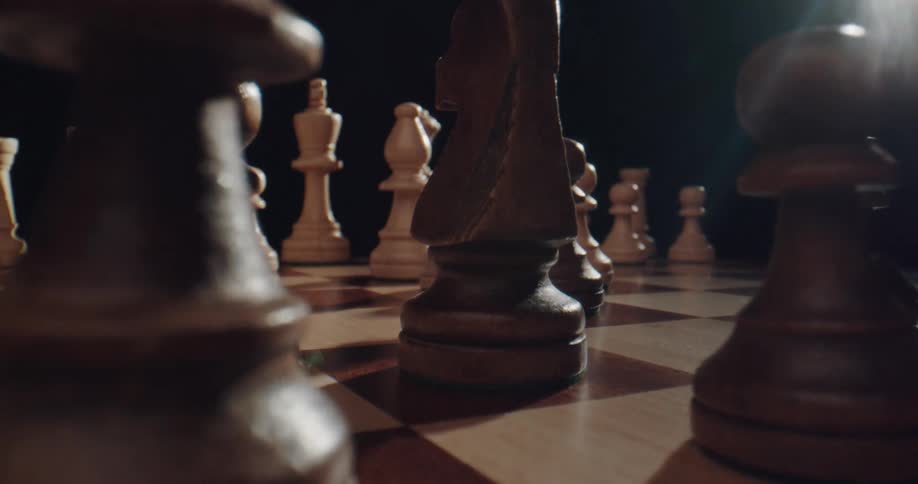 A person is playing chess indoors