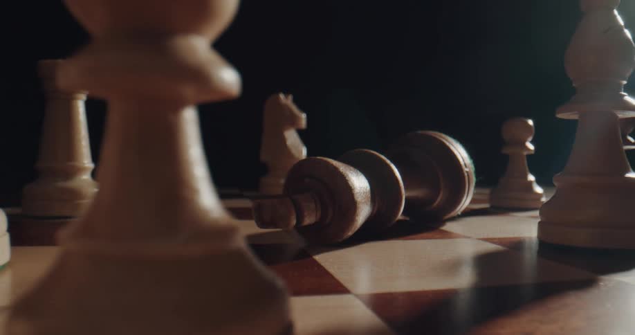 A person is playing chess board game indoors