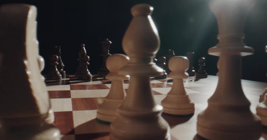 Someone is playing the board game chess indoors