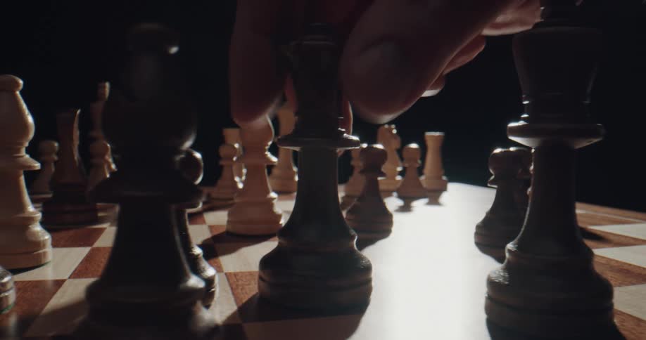 Two people playing chess on a rotating board
