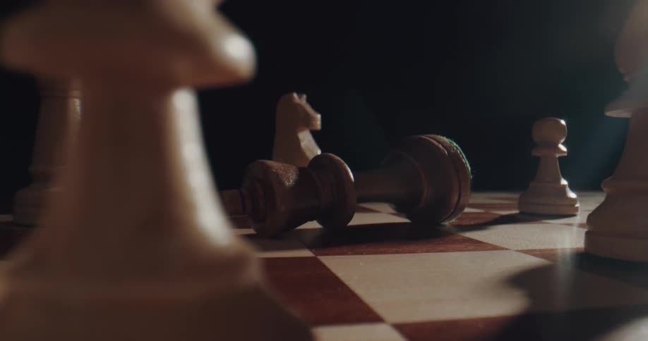 Close up of a chest board as a man lies a chest piece on its side