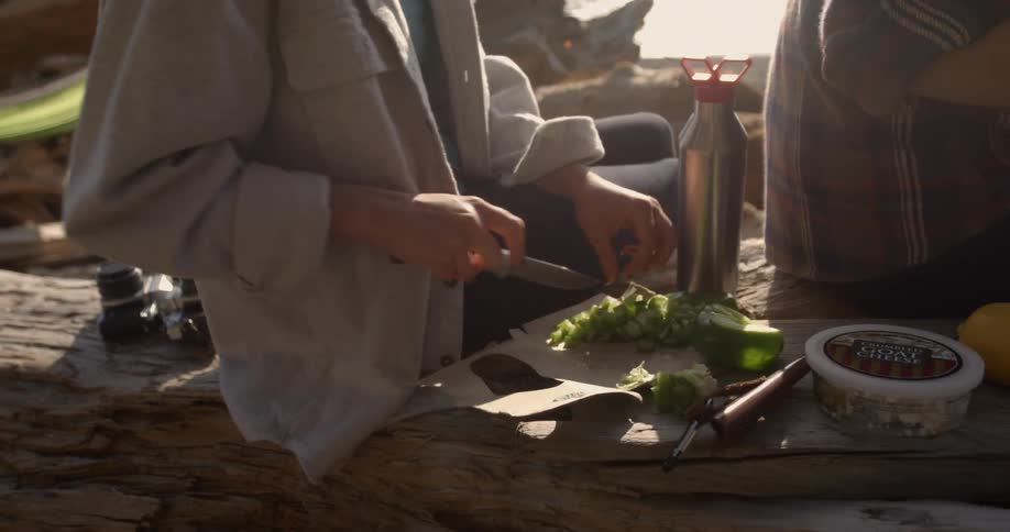 A woman is preparing food on the beach