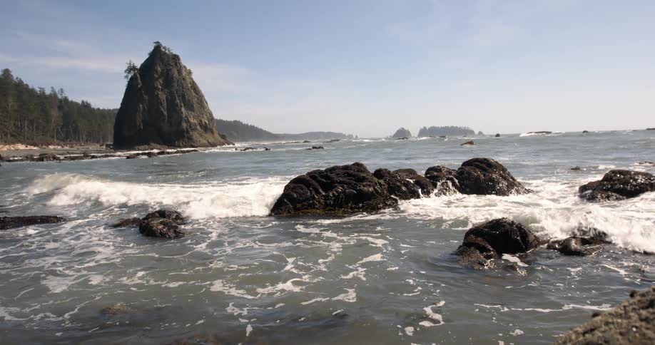 Water crashes against rocks near the shore