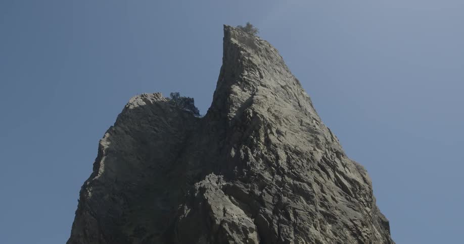 A rock juts up into the sky