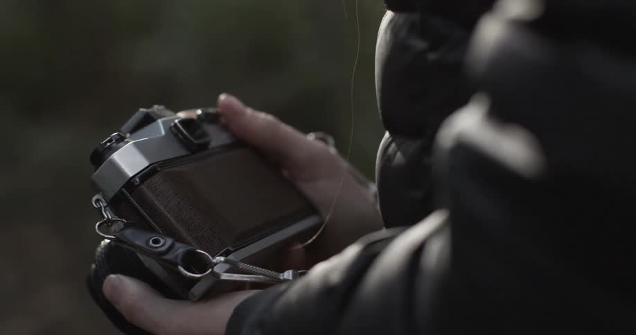 A woman holds a camera in her hands