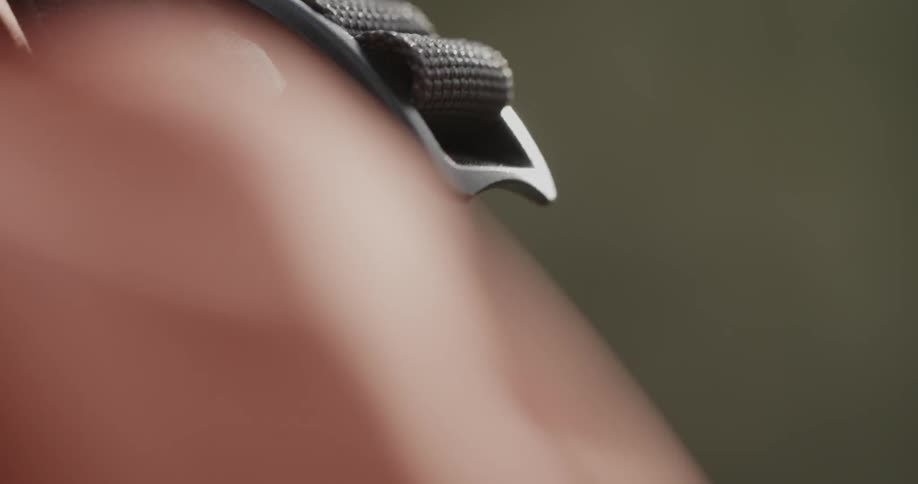 A strap on a pack is moved and adjusted