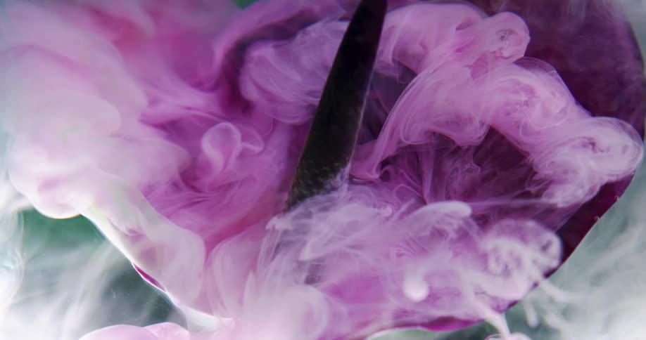 The pink color mixes in the liquid