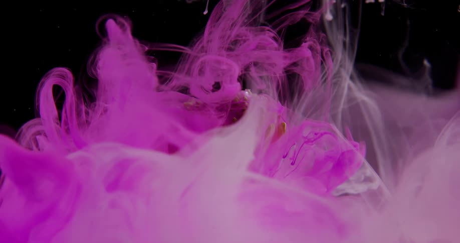 Purple paint is incorporated in liquid over a green plant