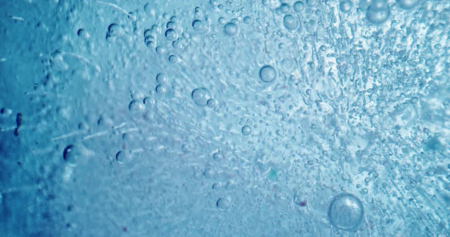 Bubbles form in a thick sheet of translucent glass