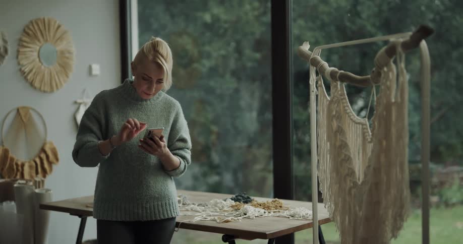 Woman in a desing studio using her cellphone