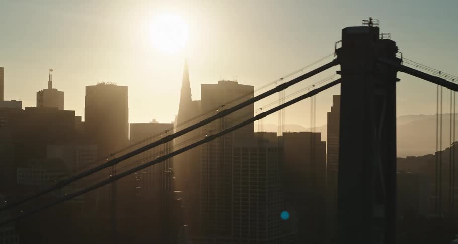 A wide shot of a city with a bridge coming into view