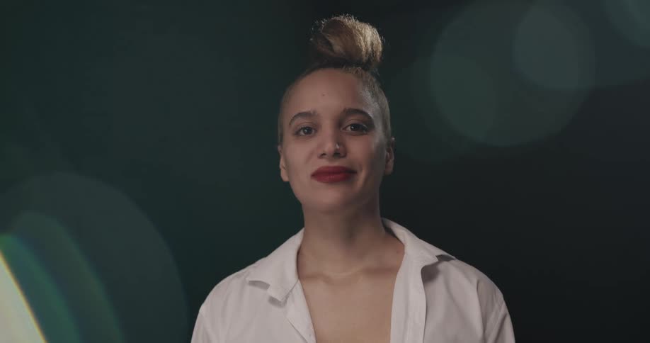 Young woman modeling looks at the camera and smiles