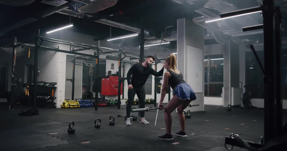 A man tutoring a woman to work out