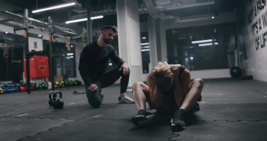 A man and woman working out in a gym