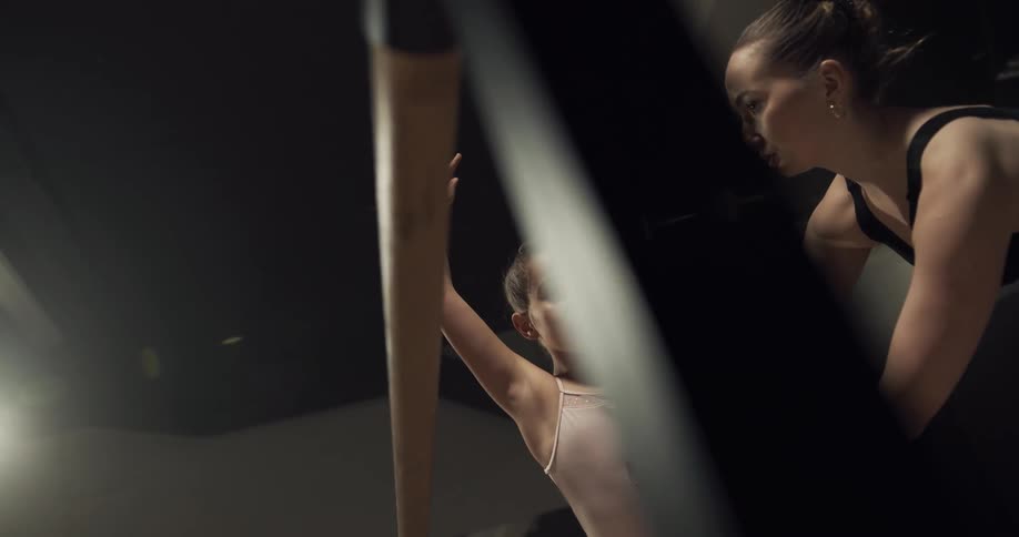 Young girl holding a pose training as a ballerina in a dance studio