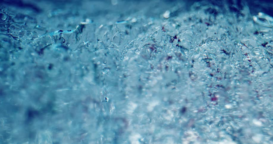 Close up of water freezing with little droplets of water as it melts