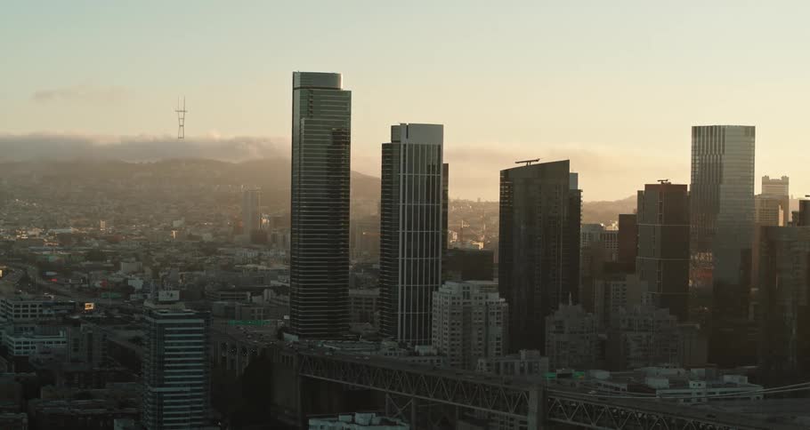 A skyline of a city with buildings and neighborhoods and fog
