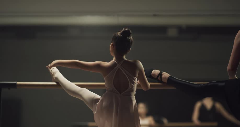 A woman and child practicing ballet