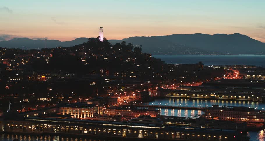 With the sun below the horizon the san francisco skyline is filled with numerous illuminated buildings