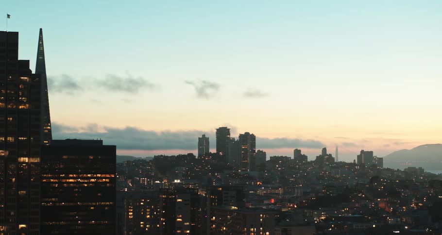 A city skyline with buildings and skyscrapers with the sky and clouds in the background